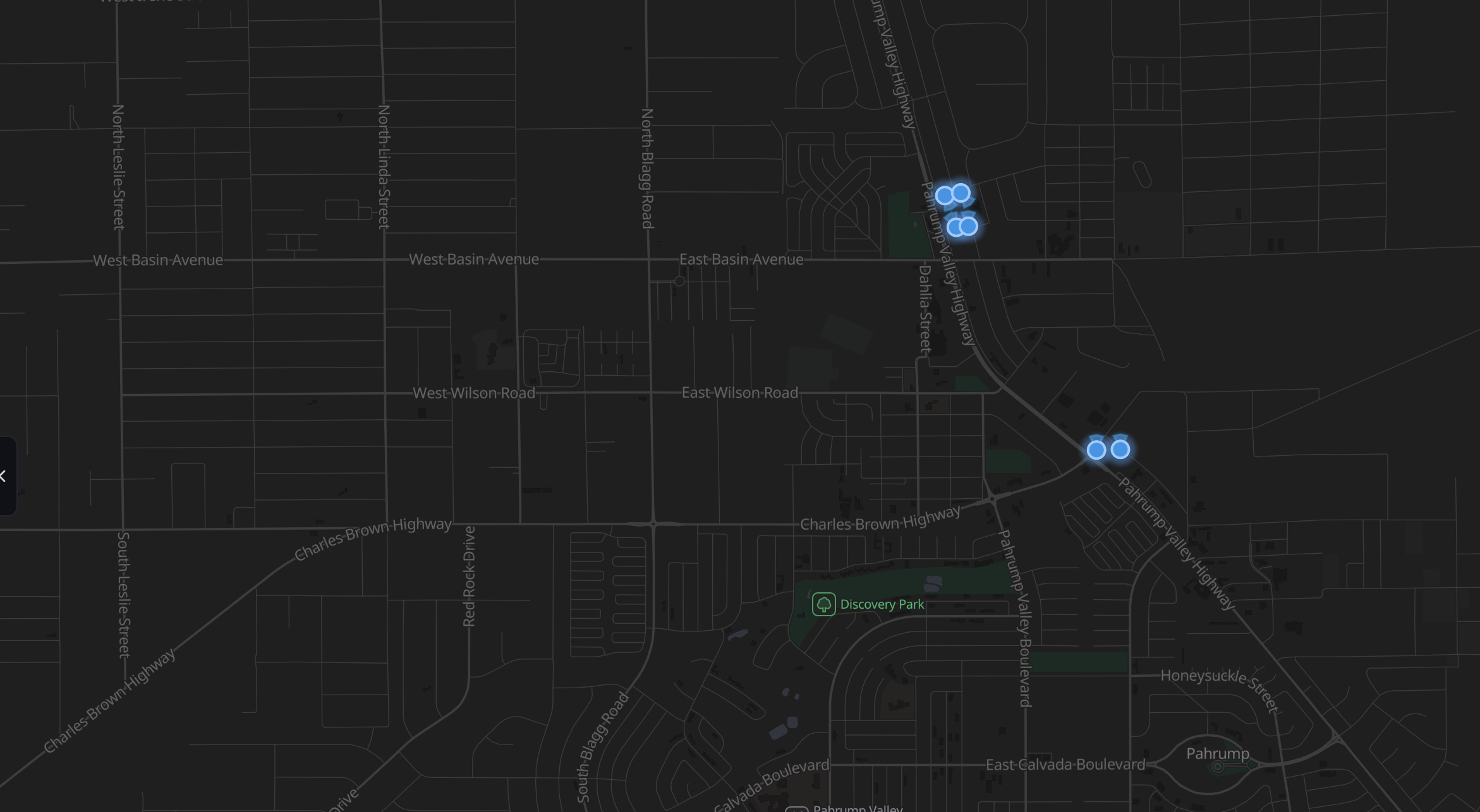 A dark street map of central Pahrump with six glowing blue markers: four clustered at the Home Depot beside Highway 160, and two on their own about a mile south.