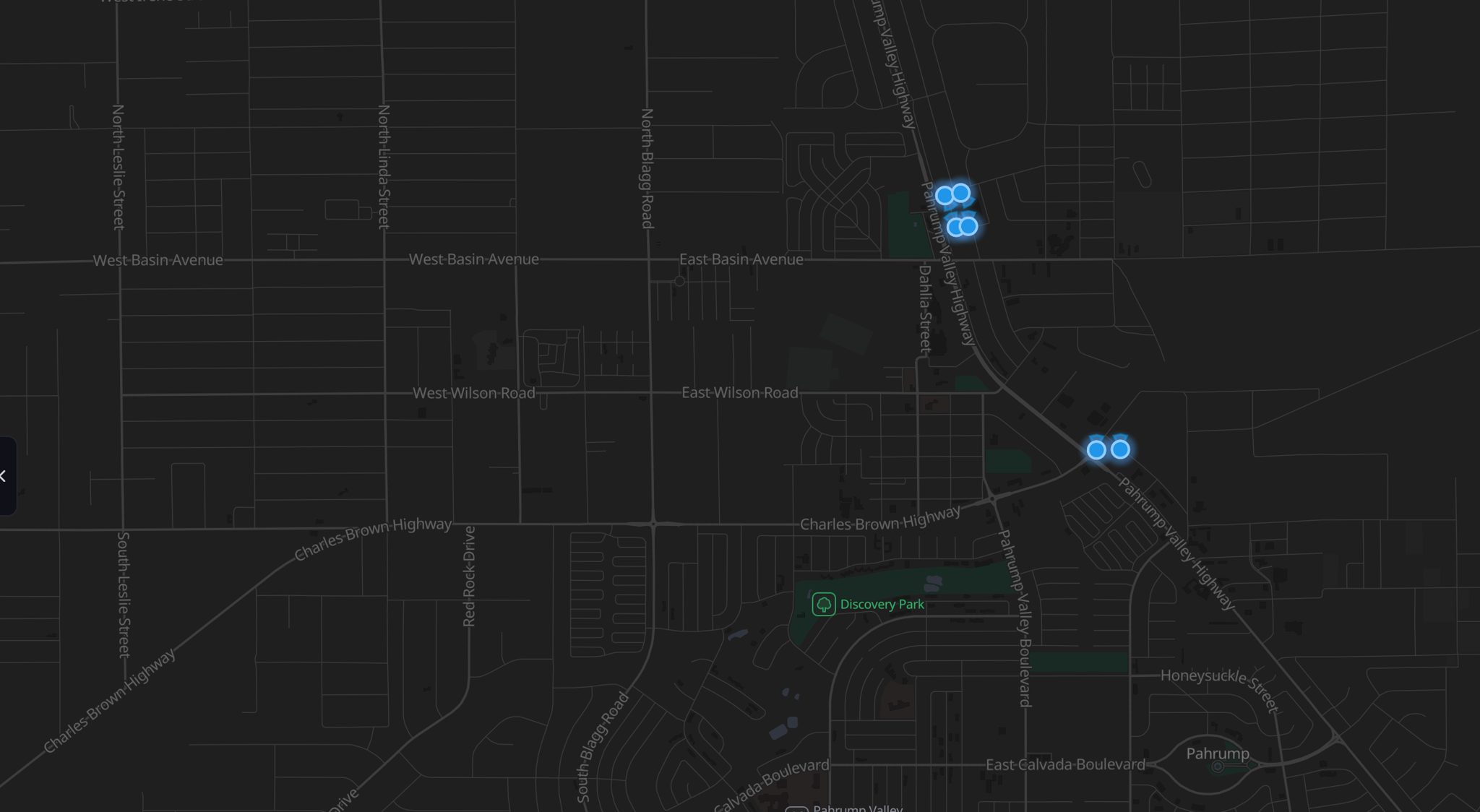 A dark street map of central Pahrump with six glowing blue markers: four clustered at the Home Depot beside Highway 160, and two on their own about a mile south.