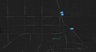 A dark street map of central Pahrump with six glowing blue markers: four clustered at the Home Depot beside Highway 160, and two on their own about a mile south.