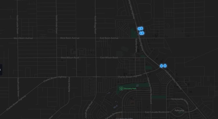 A dark street map of central Pahrump with six glowing blue markers: four clustered at the Home Depot beside Highway 160, and two on their own about a mile south.